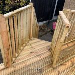 Decking with steps down to garden side entrance