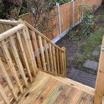Raised decking area with steps down to garden